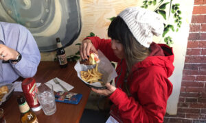 Tourist Trying Lobster Roll. Photo Provided by Maine Day Ventures