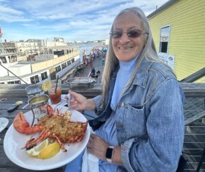 Guest with Stuffed Lobster. Photo Credit: Boone's Fish House & Oyster Room