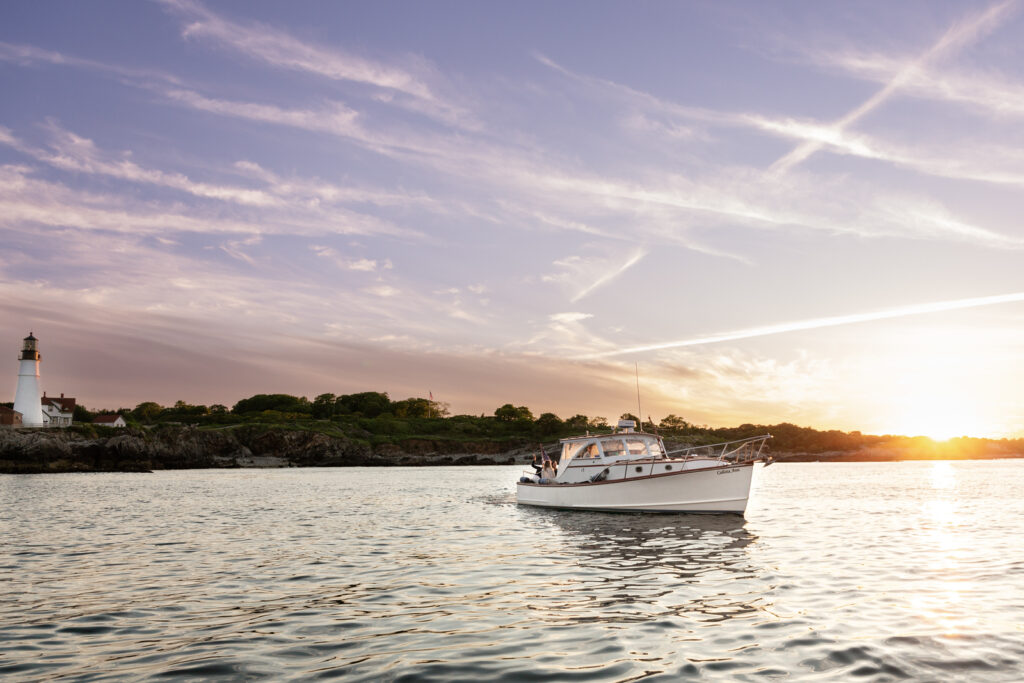 Boat at Sunset by Portland Head Light. Photo Credit: Sail Portland Maine Boat at Sunset by Portland Head Light. Photo Credit: Sail Portland Maine