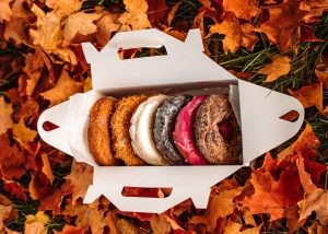 Box of Donuts in Autumn Leaves. Photo Provided by The Holy Donut