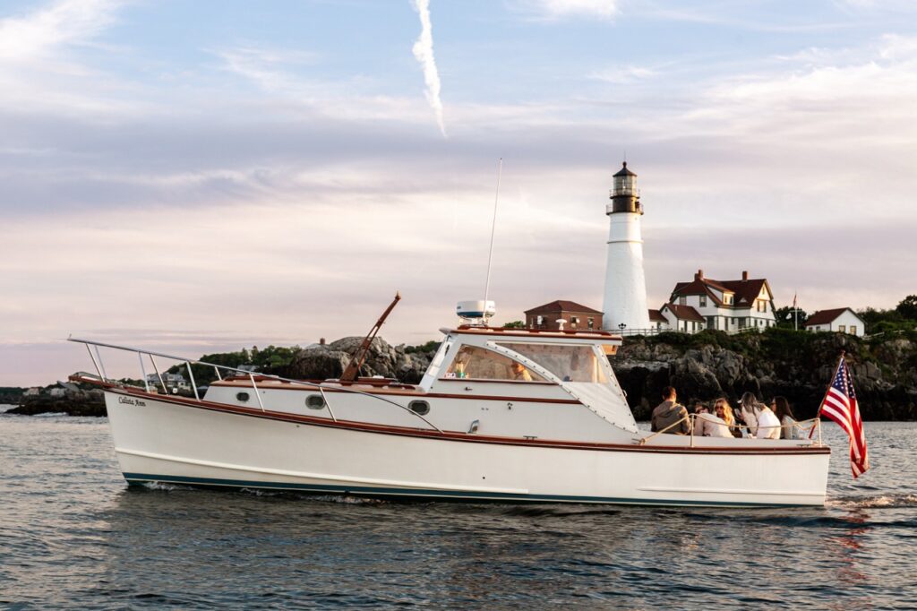 Boat Passing by Portland Head Light. Photo Credit: Sail Portland Maine Boat Passing by Portland Head Light. Photo Credit: Sail Portland Maine