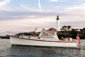 Boat Passing by Portland Head Light. Photo Credit: Sail Portland Maine Boat Passing by Portland Head Light. Photo Credit: Sail Portland Maine