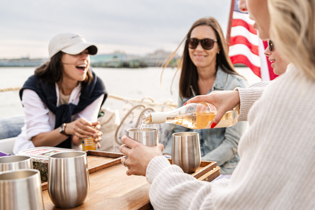 Friends Drinking Wine on Private Charter. Photo Credit: Sail Portland Maine