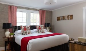 Guest room with a queen size bed. Photo Credit: Rarebrick Photography