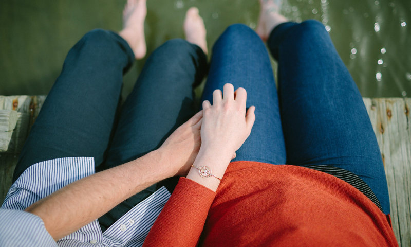 Couple on dock with bracelet. Photo Provided by Brown Goldsmiths