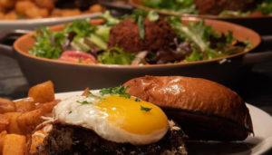 Burger and Salad. Photo Provided by Three Dollar Deweys