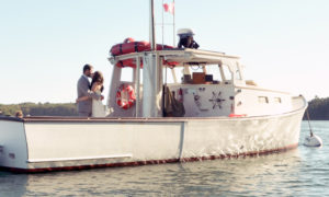 Wedding couple on boat. Photo Provided by Casco Bay Custom Charters