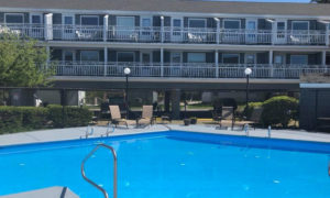 Outdoor pool and exterior of inn. Photo Provided by Grand Beach Inn