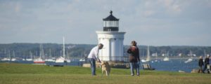 Couple with Dog in Front of Lighthouse