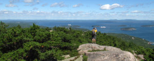 Acadia Views with Hiker at Summit, Photo Courtesy of Greater Bangor CVB