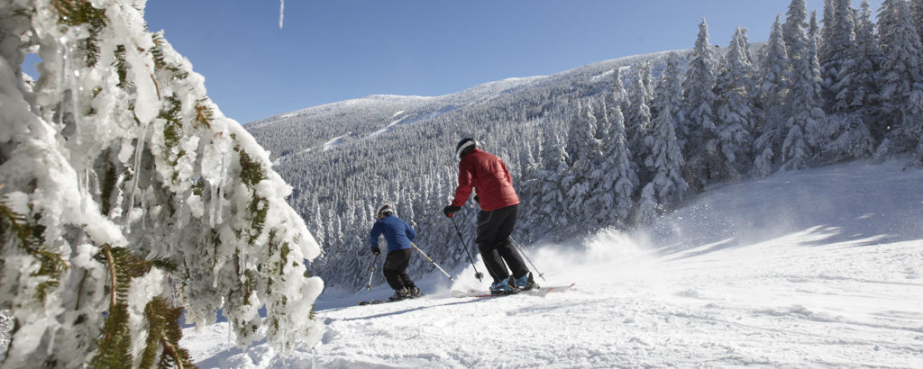 skiing downhill on snow covered mountain