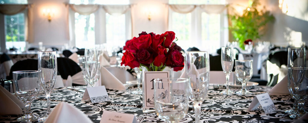 Roses on Black and White Tablecloth at Wedding, Photo Credit: Focus Photography