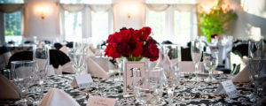 Roses on Black and White Tablecloth at Wedding, Photo Credit: Focus Photography