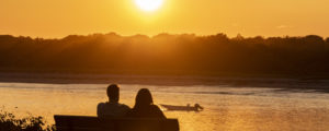 Couple Sitting on Bench at Kettle Cove. Photo Credit: CFW Photography