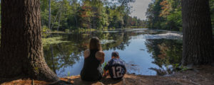 Mother and Son Sitting by Woods Pond, Photo Credit: CFW Photography