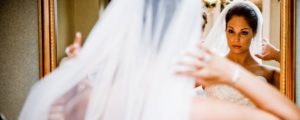 Bride Getting Ready in Mirror, Photo Credit: Focus Photography