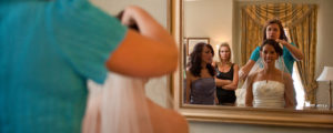 Bride Getting Ready in Front of Mirror, Photo Credit: Focus Photography