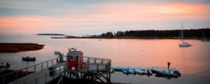 Couple on dock, sunset over waterfront. Photo Credit: Russell Caron Wedding Photography Couple on dock, sunset over waterfront. Photo Credit: Russell Caron Wedding Photography