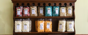 Shelves of Locally Made Colorful Popcorn, Photo Credit: Amy Tolk via Coastal Maine Popcorn Company