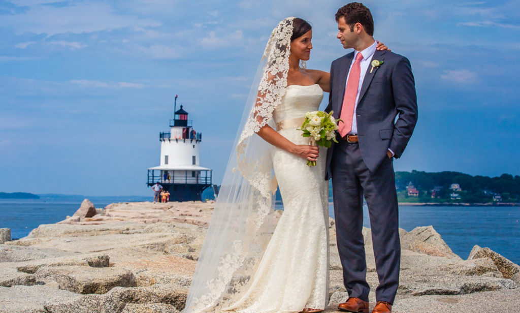 Bride and Groom Posing in Front of Lighthouse, Photo Credit: Luxury Hero