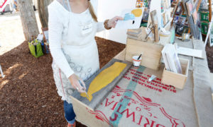 Artist Painting Wooden Plant at Freeport Fall Festival, Photo Courtesy of Visit Freeport