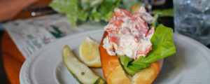 Plated Lobster Roll with Side of Pickle and Lemon, Photo Courtesy of Kirsten Alana / GLP Films