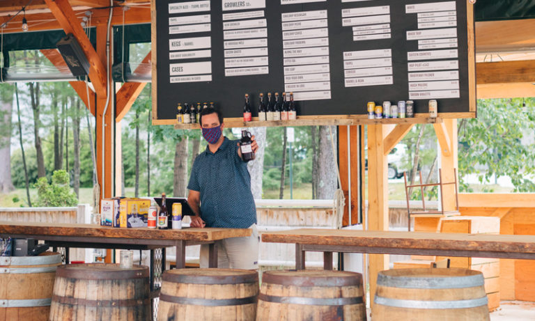Server in Mask in Tasting Room, Photo Courtesy of Mat Trogner, via Allagash Brewing Server in Mask in Tasting Room, Photo Courtesy of Mat Trogner, via Allagash Brewing