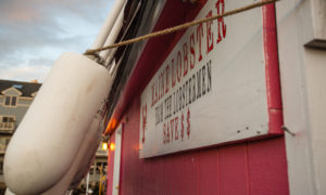 Maine Lobster Sign on Building with Line of Hanging Buoys, Photo Credit: Visit USA Parks and Tobey Schmidt