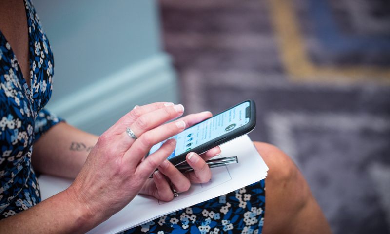 Woman Scrolling on Phone, Photo Credit: Focus Photography