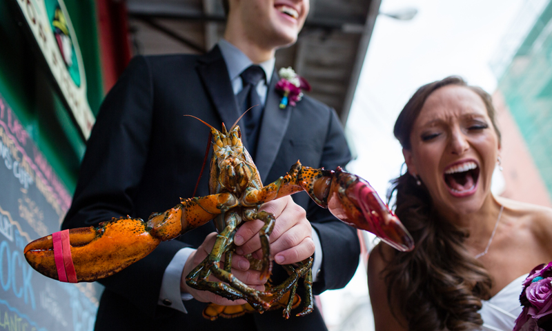 Couple Kissing Holding Lobster, Photo Credit: Emilie Inc.