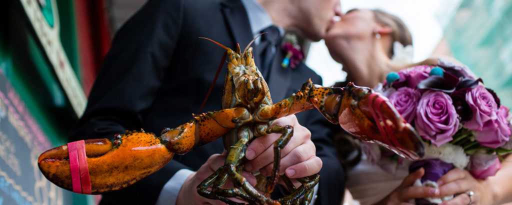 Couple Kissing Holding Lobster, Photo Credit: Emilie Inc.