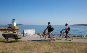 Biking by Lighthouse. Photo Credit: Serena Folding