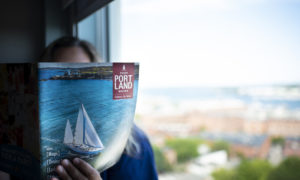 Holding Visitors Guide Photo Credit - Capshore Photography