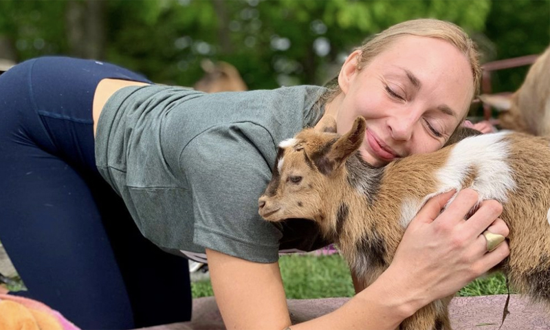 Goat Yoga Snuggles. Photo Credit: Ashley Flowers