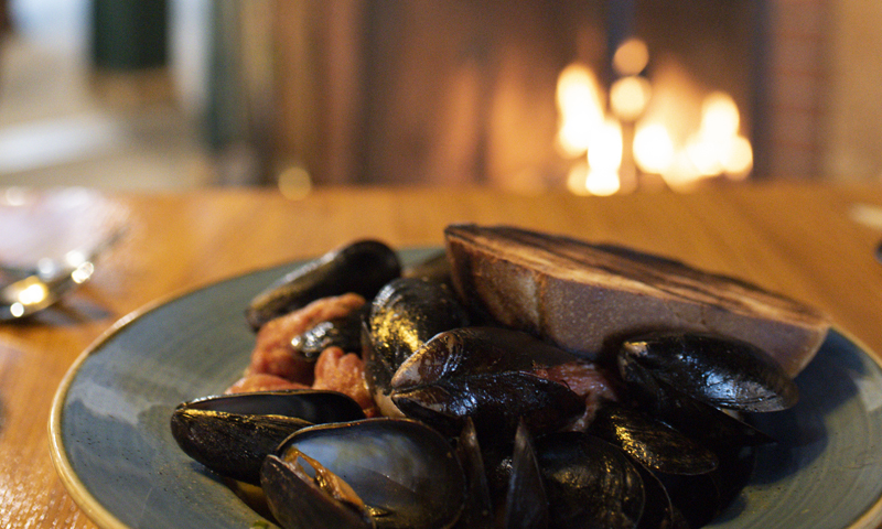 Broad Arrow Tavern Mussels near Fireplace, Photo Credits: Capshore Photography 