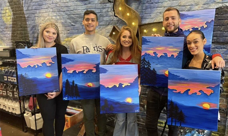 Group with finished paintings. Photo Courtesy of Muse Paintbar