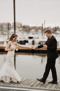 Bride and groom on docks - photo by The Camerados