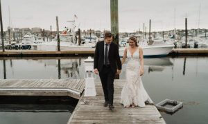 Bride and groom on docks - photo by The Camerados