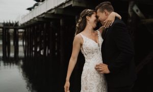 Bride and groom on docks - photo by The Camerados