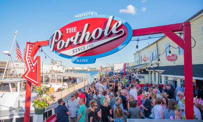 The Porthole sign over crowd on deck, Photo Credits: The Porthole