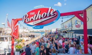 The Porthole sign over crowd on deck, Photo Credits: The Porthole