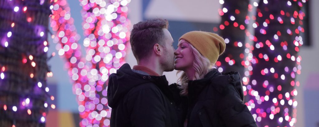 Couple in front of Pandora Christmas lights, Photo Credit: Knack Factory