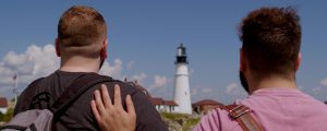 Couple backs to camera looking at Portland Head Light, Photo Credit: Knack Factory