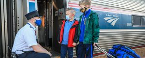 Kids and Conductor Boarding Amtrak Downeaster. Photo Courtesy of NNEPRA