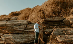Couple by Rocks. Photo Credit: Claire Gregory Photography / clairegregregoryphotography.com