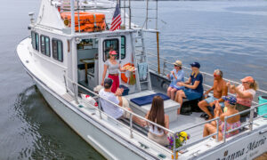 Group Eating on Boat Charter. Photo Credit: PGM Photography