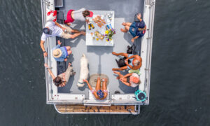 Group Eating on Boat Charter. Photo Credit: PGM Photography