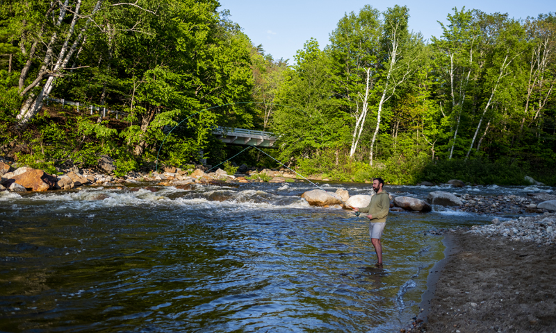 Man fishing across river, Photo credit to Capshore Photography