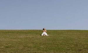 Woman in field listing. Photo Courtesy of @MarriottBonvoy