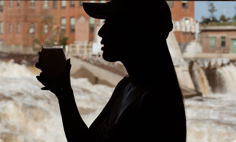 silhouette of woman with beer listing. Photo Courtesy of @MarriottBonvoy